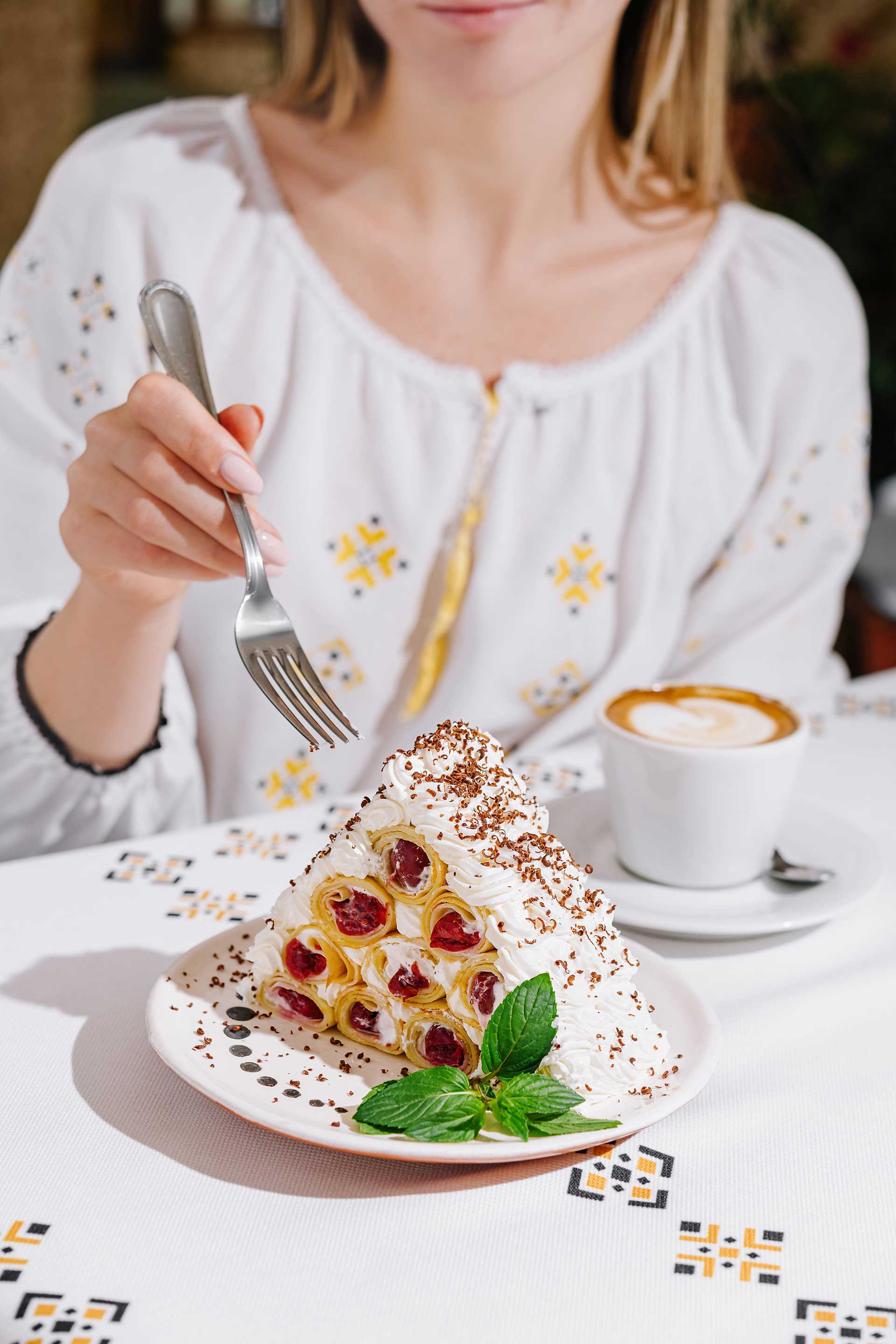 woman-enjoying-delicious-pavlova-dessert-at-cafe-2024-04-18-23-22-07-utc.jpg